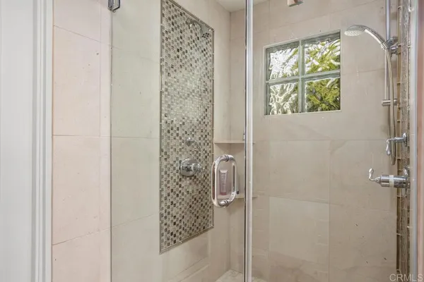 a bathroom with a shower and a window