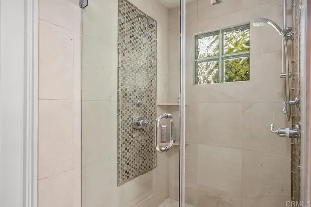a bathroom with a shower and a window