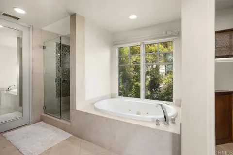 a bathroom with a bathtub and shower