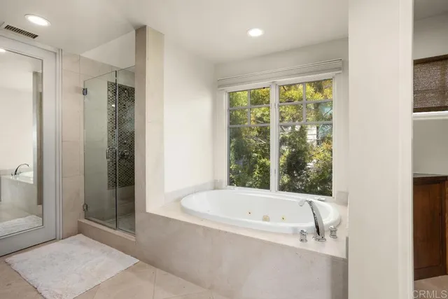 a bathroom with a bathtub and shower