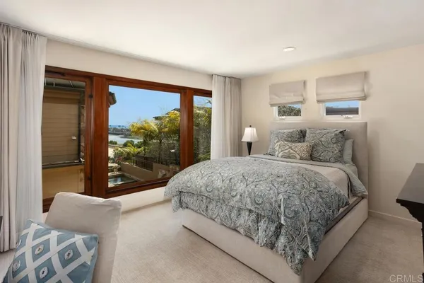 a bedroom with a large bed and a large window