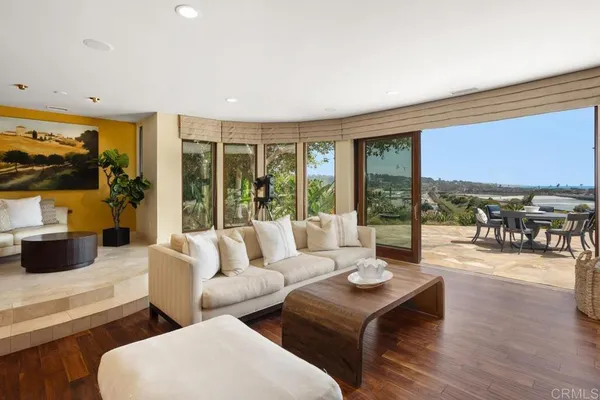 a living room with furniture and floor to ceiling window