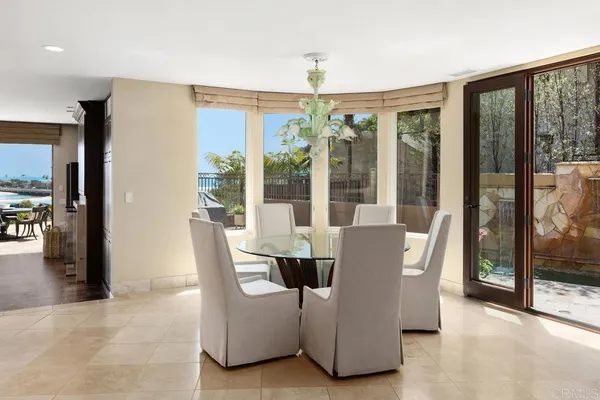 a dining room with furniture and large windows