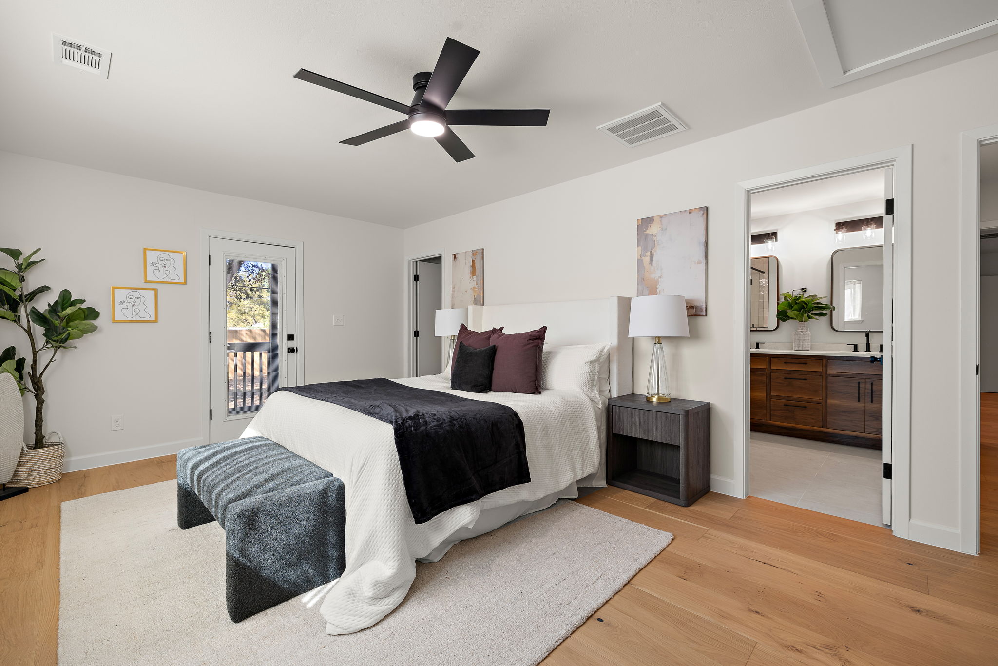 8102 Burrell Drive Austin, TX 78757 - Photo 17 of 35 a bedroom with a bed and a chandelier