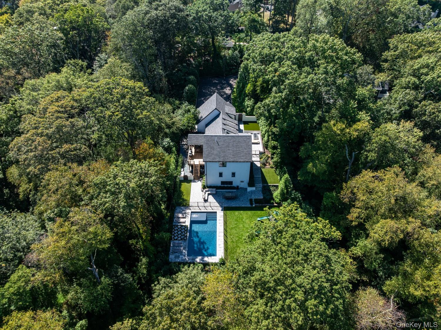 20 Tall Tree Court Cold Spring Harbor, NY 11724 - Photo 1 of 1 an aerial view of a house with a yard and fountain in middle