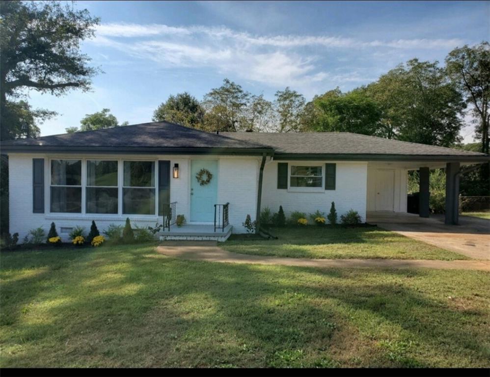 2197 Wallingford Drive Decatur, GA 30032 - Photo 1 of 1 a front view of a house with a garden