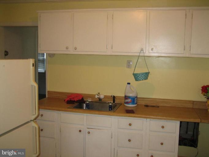 11705 Idlewood Road Silver Spring, MD 20906 - Photo 4 of 10 a kitchen with a sink and cabinets
