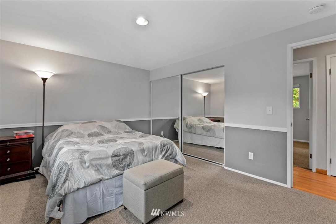 12656 177th Place Southeast Renton, WA 98059 - Photo 13 of 27 a bed room with a bed and a lamp
