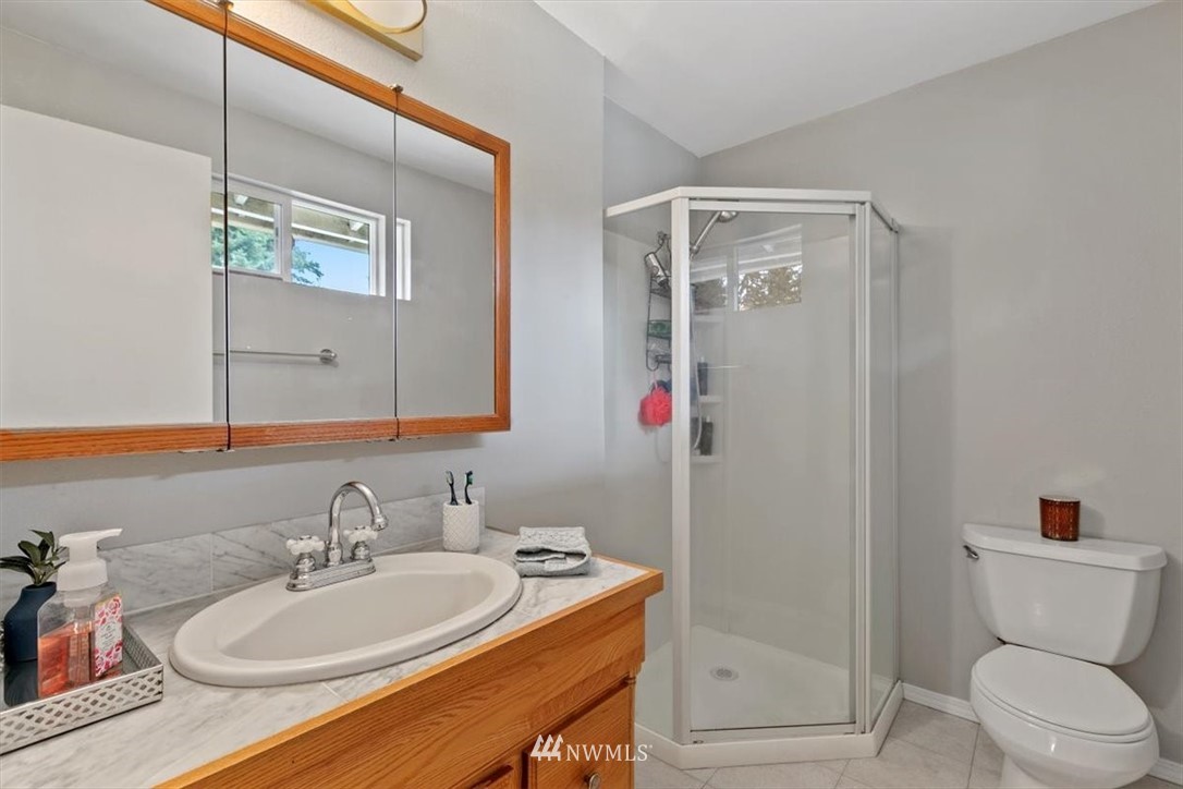 12656 177th Place Southeast Renton, WA 98059 - Photo 15 of 27 a bathroom with a sink a toilet and shower