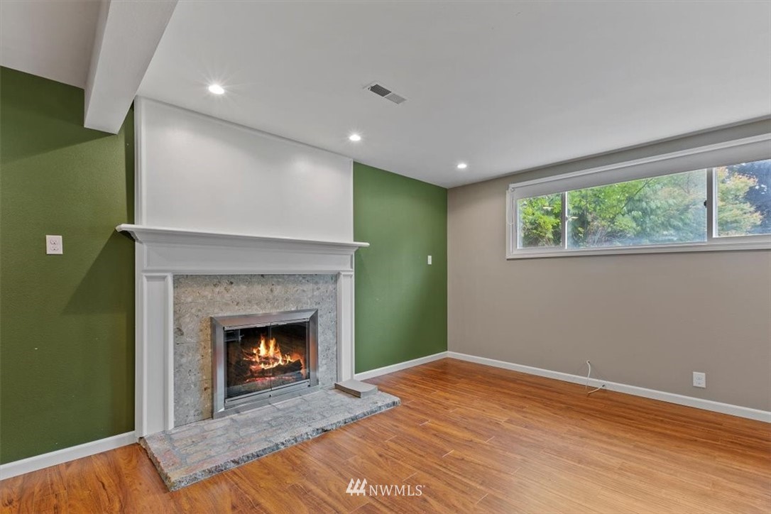 12656 177th Place Southeast Renton, WA 98059 - Photo 20 of 27 a view of empty room with wooden floor and fireplace