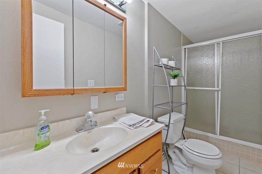 12656 177th Place Southeast Renton, WA 98059 - Photo 22 of 27 a bathroom with a sink toilet vanity and shower