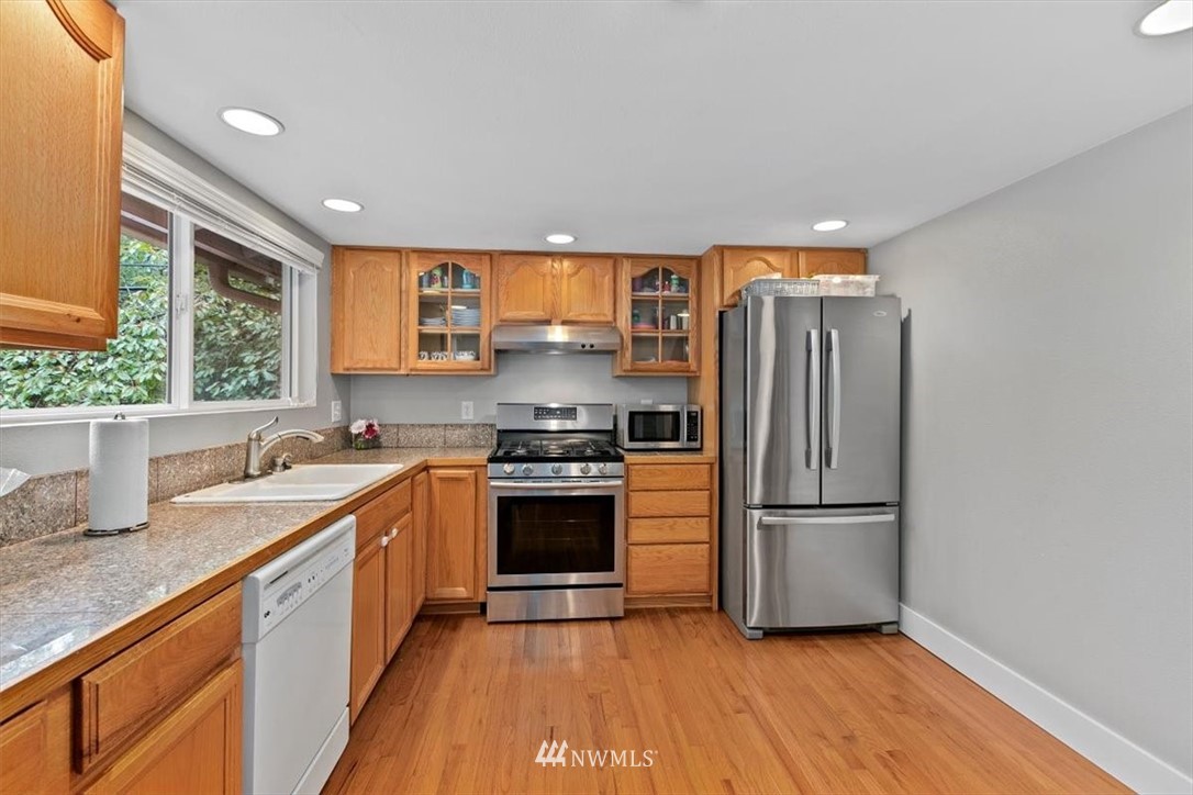 12656 177th Place Southeast Renton, WA 98059 - Photo 8 of 27 a kitchen with a refrigerator and a sink