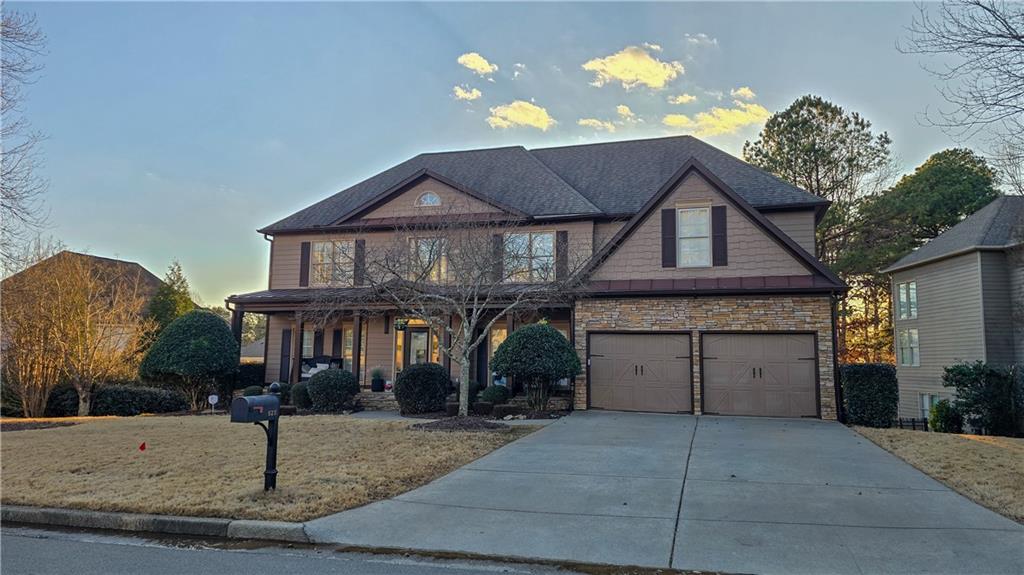 a front view of a house with a yard and garage