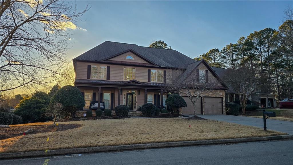 523 Waterside Court Canton, GA 30114 - Photo 2 of 28 a front view of a house with a yard and garage