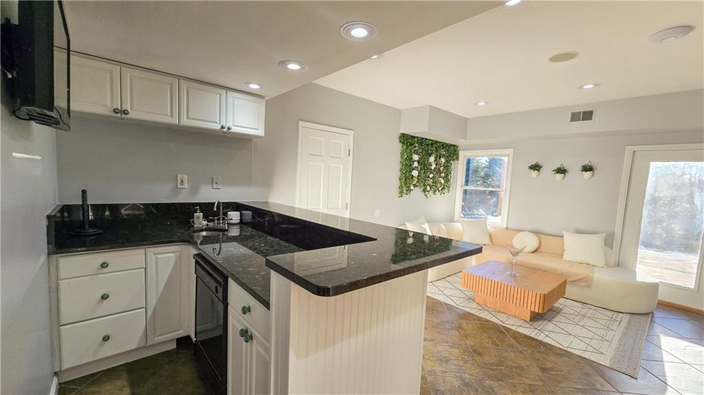 523 Waterside Court Canton, GA 30114 - Photo 21 of 28 a kitchen with granite countertop a sink and cabinets