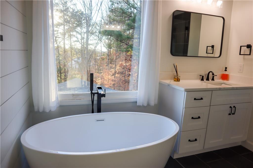 523 Waterside Court Canton, GA 30114 - Photo 24 of 28 a bathroom with a bathtub and a window