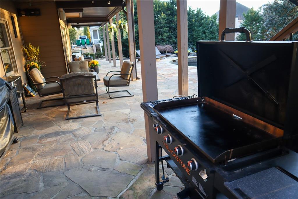 523 Waterside Court Canton, GA 30114 - Photo 26 of 28 a living room with patio furniture and a grill