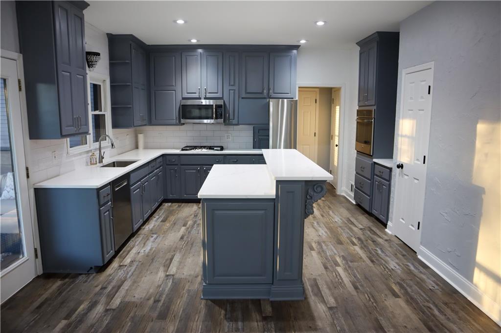 523 Waterside Court Canton, GA 30114 - Photo 7 of 28 a large kitchen with stainless steel appliances sink refrigerator and microwave