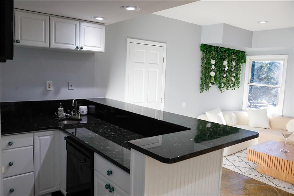 523 Waterside Court Canton, GA 30114 - Photo 8 of 28 a kitchen with a sink a stove and cabinets