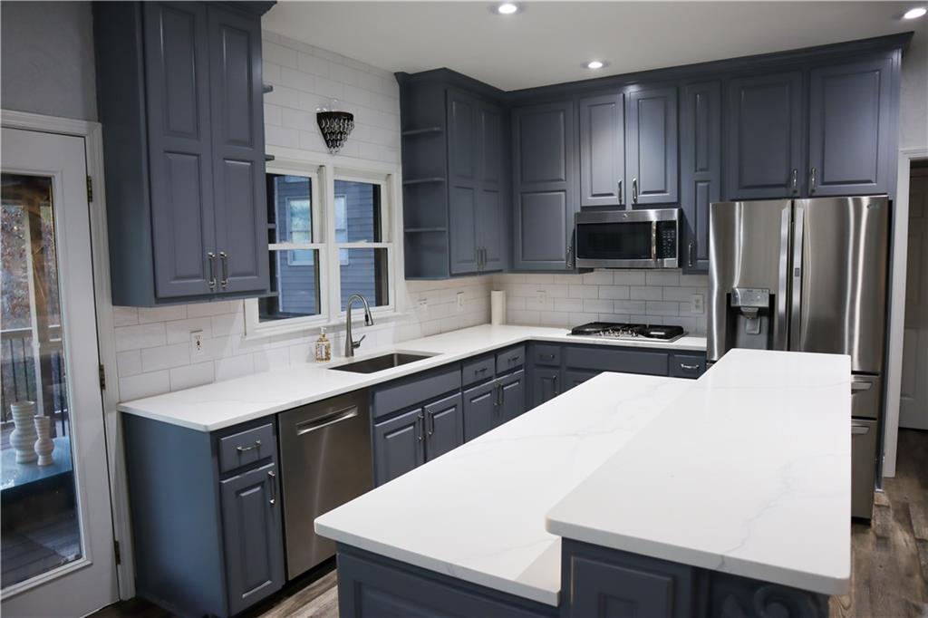 523 Waterside Court Canton, GA 30114 - Photo 9 of 28 a kitchen with a sink a stove a refrigerator and cabinets