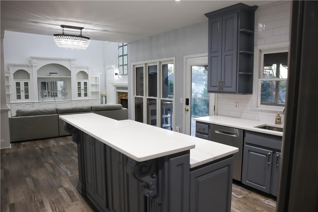 523 Waterside Court Canton, GA 30114 - Photo 10 of 28 a kitchen with a sink cabinets and wooden floor