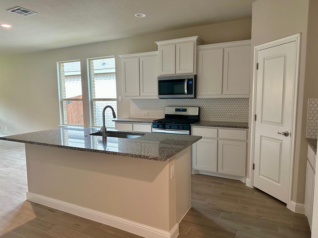 11505 Adare Drive Haslet, TX 76052 - Photo 4 of 17 a kitchen with appliances a sink and a counter top space