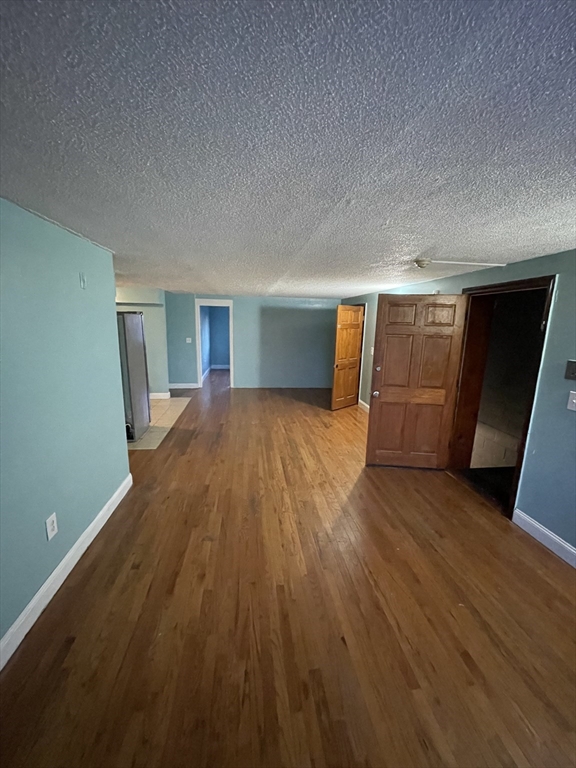 85 Munroe Street Boston, MA 02119 - Photo 7 of 15 a view of empty room with wooden floor