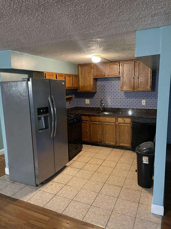 85 Munroe Street Boston, MA 02119 - Photo 8 of 15 a kitchen with stainless steel appliances granite countertop a refrigerator and a sink