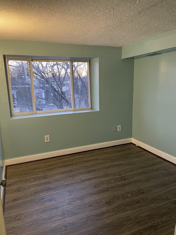 85 Munroe Street Boston, MA 02119 - Photo 10 of 15 a view of a room with wooden floor and large window