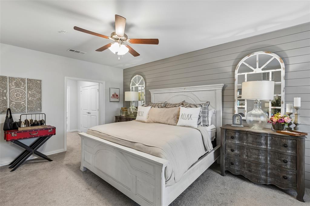 651 Watters Road, Unit 7204 Allen, TX 75013 - Photo 16 of 40 a bed room with a bed and a chandelier