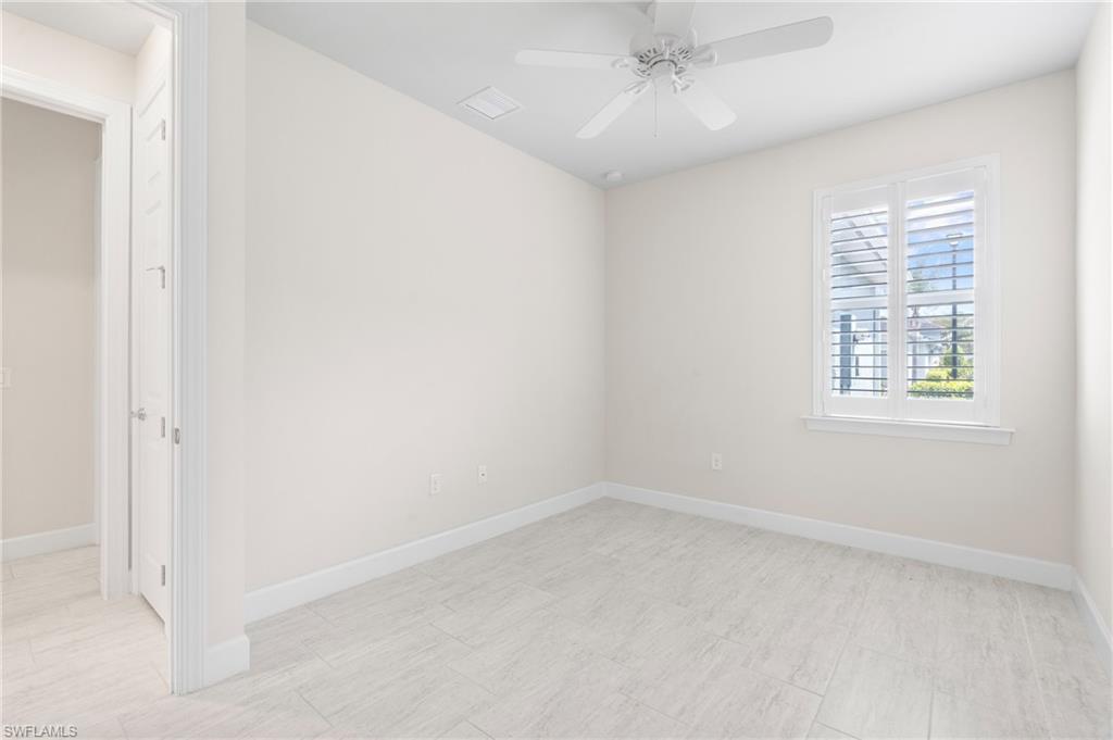 20128 Torch Key Way Estero, FL 33928 - Photo 15 of 50 an empty room with a window and ceiling fan