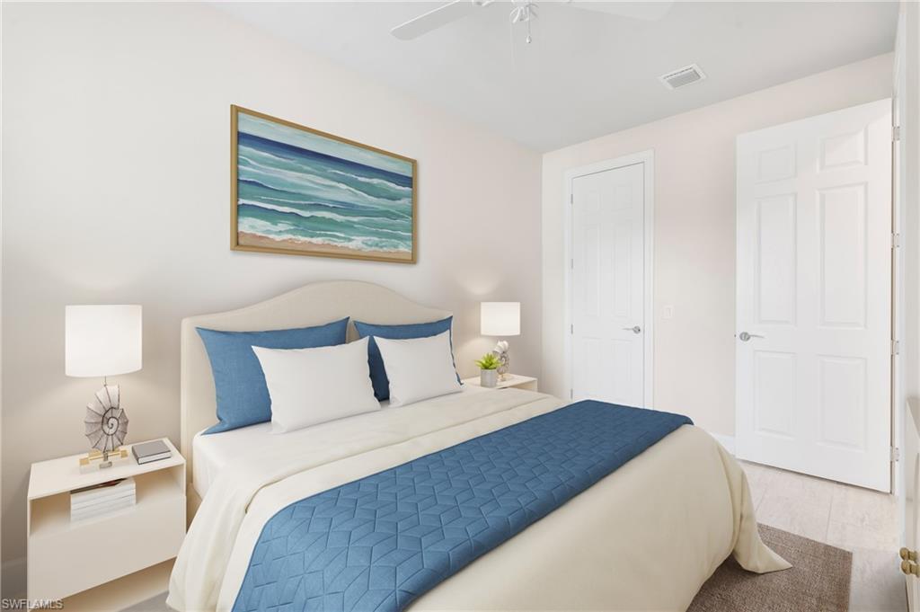 20128 Torch Key Way Estero, FL 33928 - Photo 17 of 50 a bedroom with a bed and a lamp