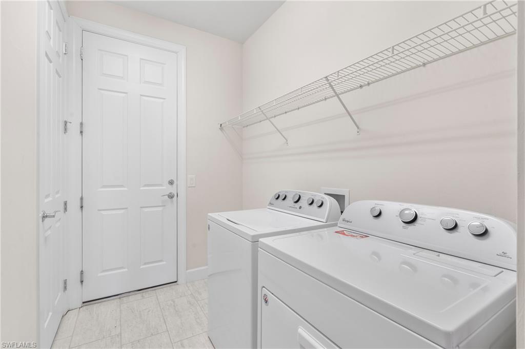 20128 Torch Key Way Estero, FL 33928 - Photo 22 of 50 a utility room with dryer and washer