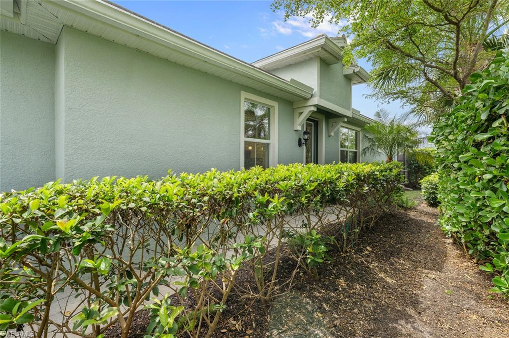 20128 Torch Key Way Estero, FL 33928 - Photo 29 of 50 a view of a house with a flower garden