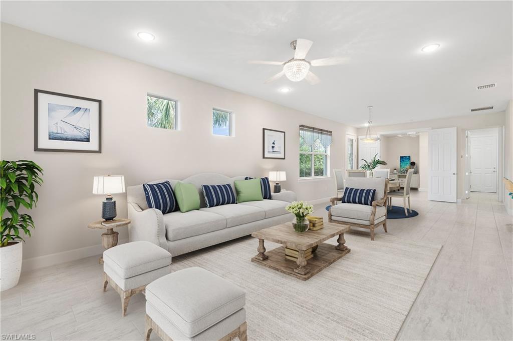 20128 Torch Key Way Estero, FL 33928 - Photo 6 of 50 a living room with furniture and a chandelier