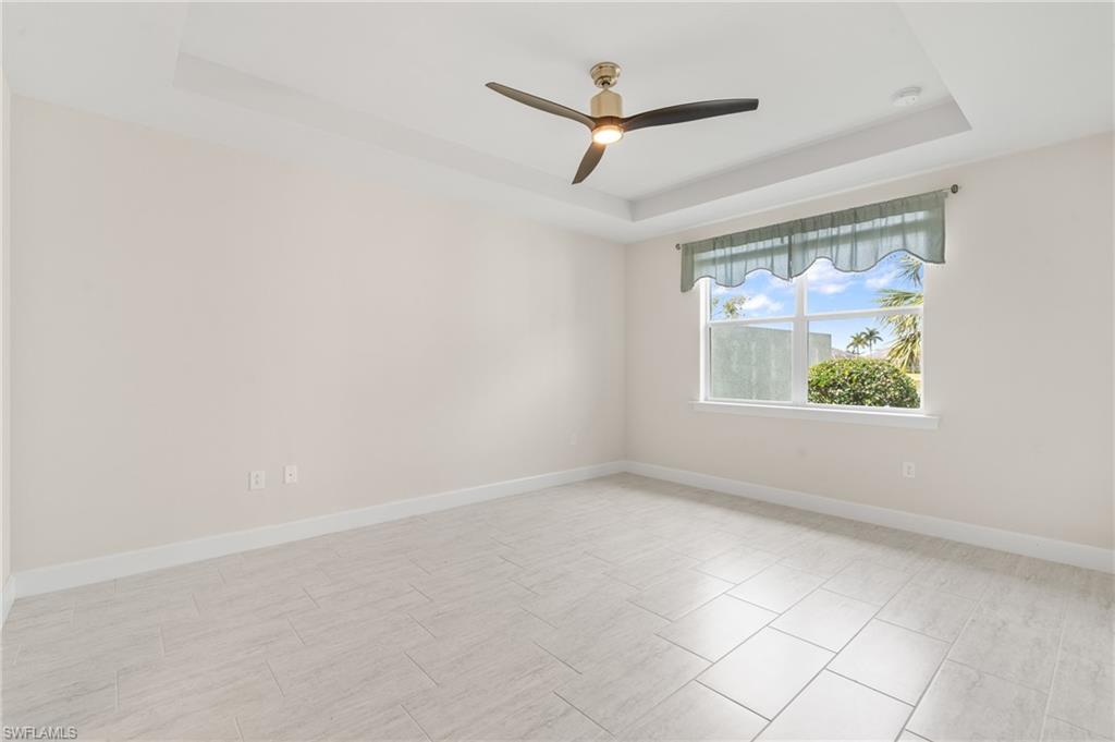 20128 Torch Key Way Estero, FL 33928 - Photo 10 of 50 an empty room with window and ceiling fan