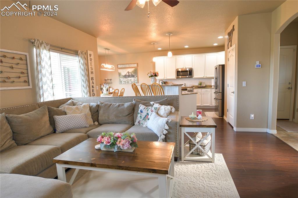 6290 Bearcat Loop Colorado Springs, CO 80925 - Photo 20 of 49 a living room with furniture and a chandelier