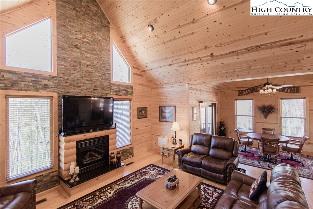 308 Warren Way Road Purlear, NC 28665 - Photo 12 of 49 a living room with furniture a flat screen tv and a fireplace