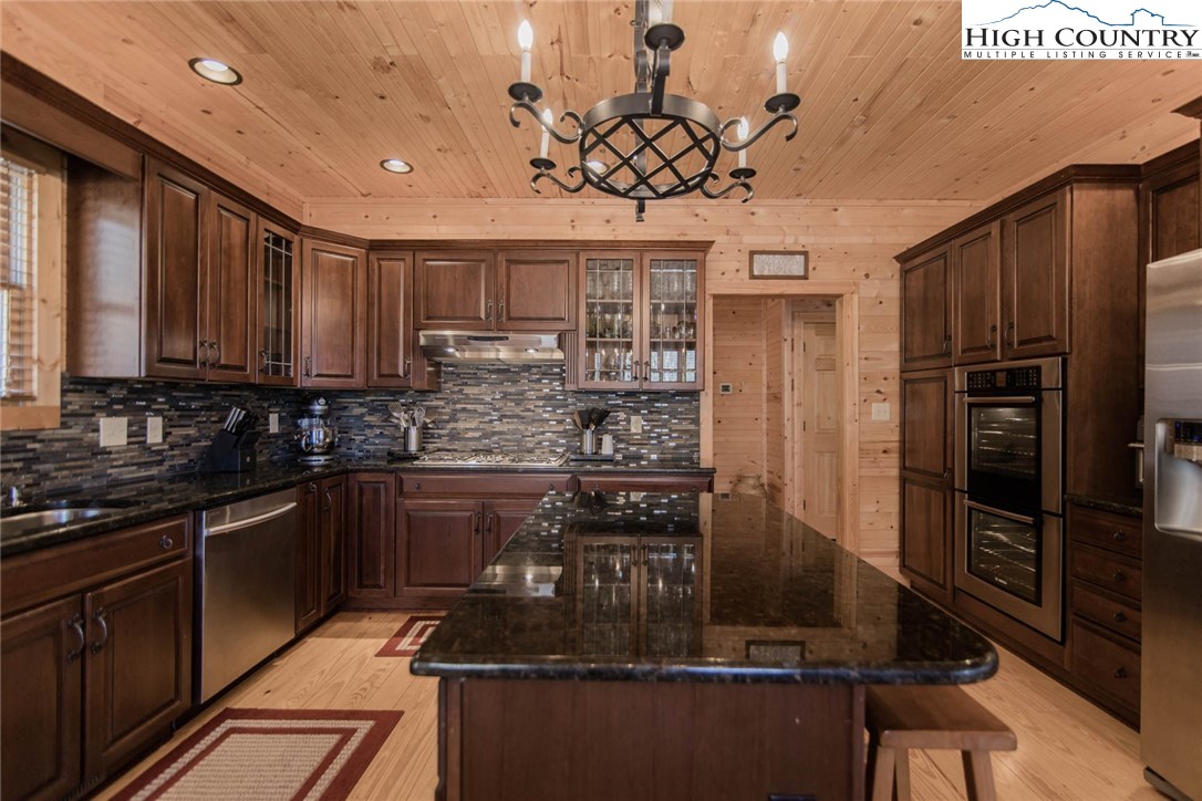 308 Warren Way Road Purlear, NC 28665 - Photo 20 of 49 a kitchen with kitchen island granite countertop a stove cabinets and refrigerator