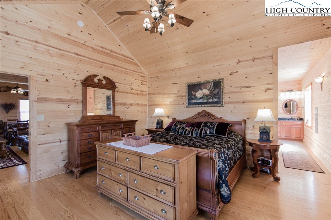 308 Warren Way Road Purlear, NC 28665 - Photo 21 of 49 a bed room with furniture and a chandelier