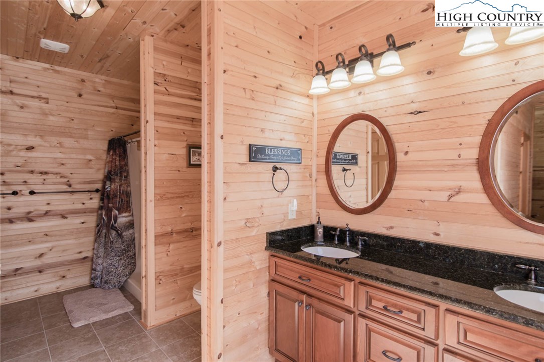 308 Warren Way Road Purlear, NC 28665 - Photo 22 of 49 a bathroom with a sink and a mirror