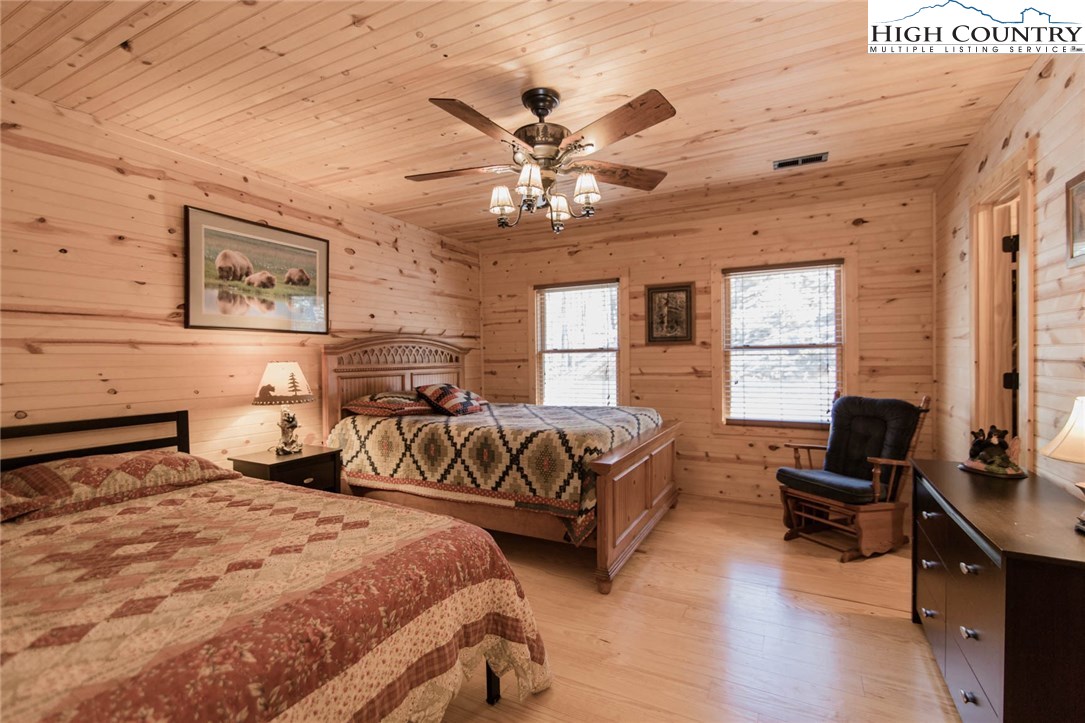 308 Warren Way Road Purlear, NC 28665 - Photo 29 of 49 a spacious bedroom with two beds and a computer on a desk