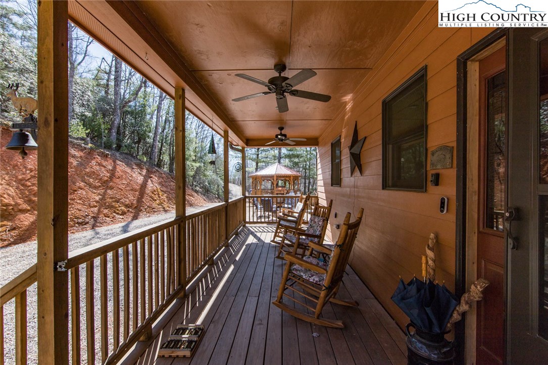 308 Warren Way Road Purlear, NC 28665 - Photo 3 of 49 a view of a porch with furniture and wooden floor