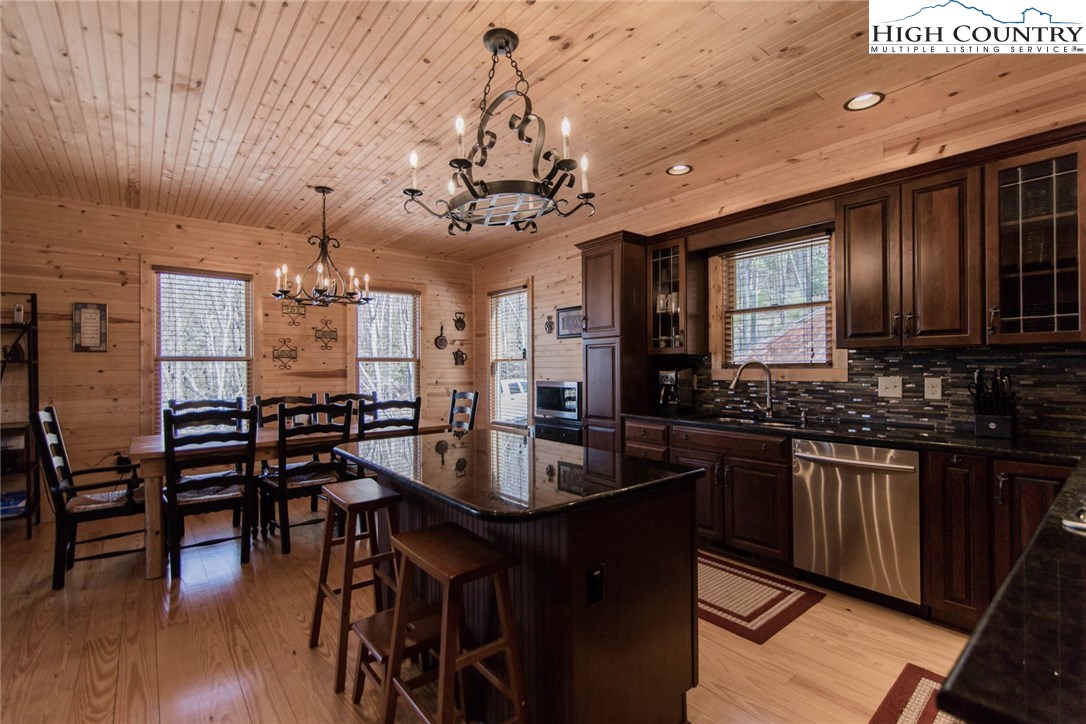 308 Warren Way Road Purlear, NC 28665 - Photo 8 of 49 a kitchen with stainless steel appliances granite countertop a stove a refrigerator a kitchen island a dining table and chairs with wooden floor