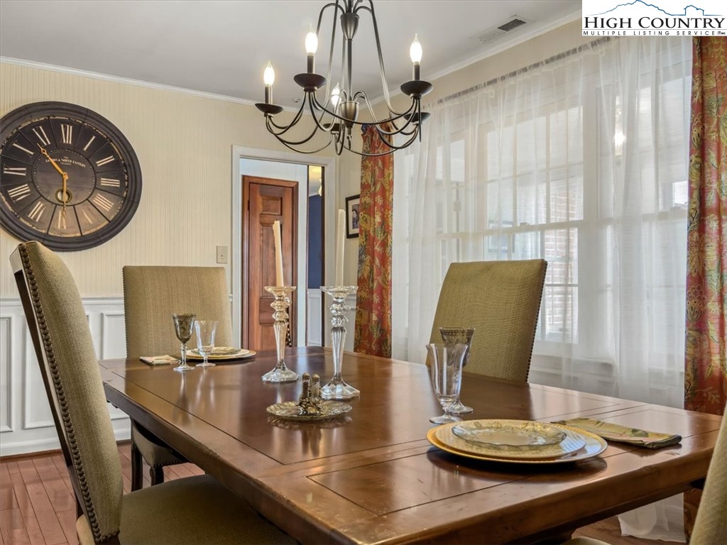 438 Glade Valley Road Glade Valley, NC 28627 - Photo 16 of 50 a view of a dining room with furniture window and wooden floor