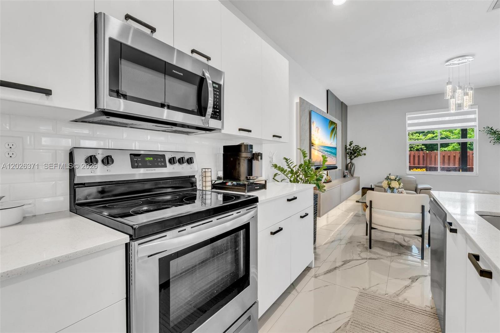 2273 Northwest 131st Circle Miami, FL 33167 - Photo 12 of 46 a kitchen with stainless steel appliances a stove microwave and cabinets