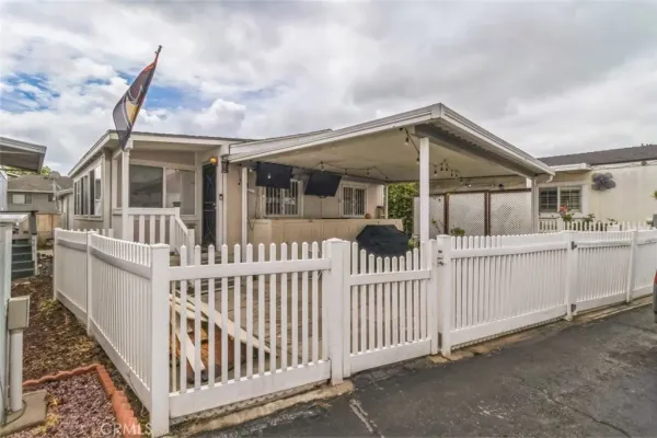 a view of a house with wooden fence