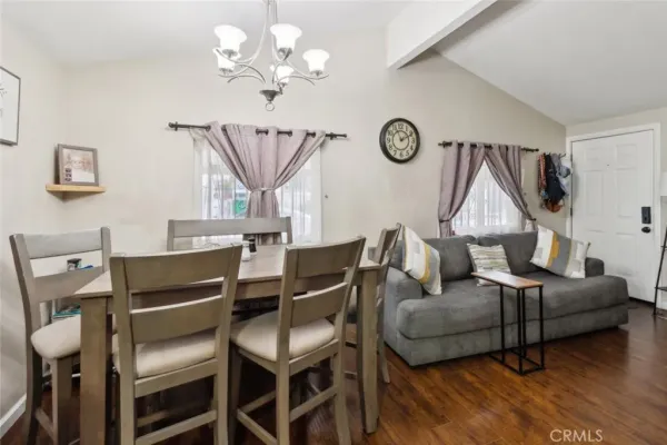 a living room with furniture a table and a chandelier
