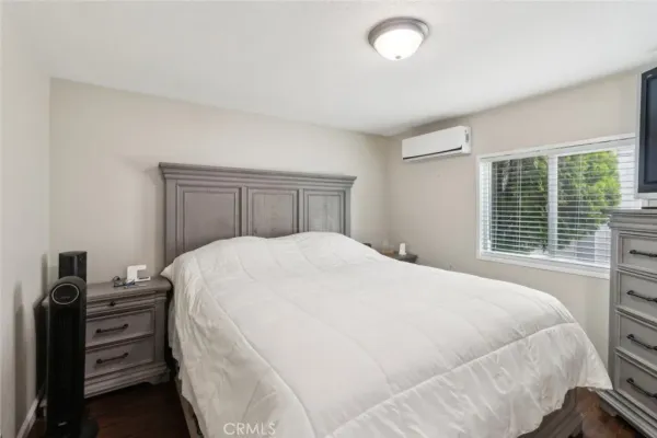a large bed sitting in a bedroom next to a window and dresser