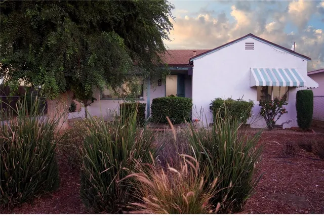 a front view of a house with garden